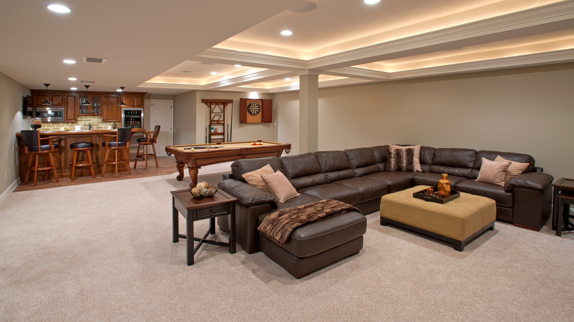 Luxury basement remodel with pool table and couch in the lehigh valley, pa by Penn Contractors 