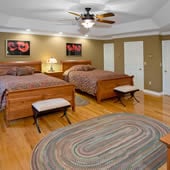 guest bedroom remodel with two beds and multicolor area rug 